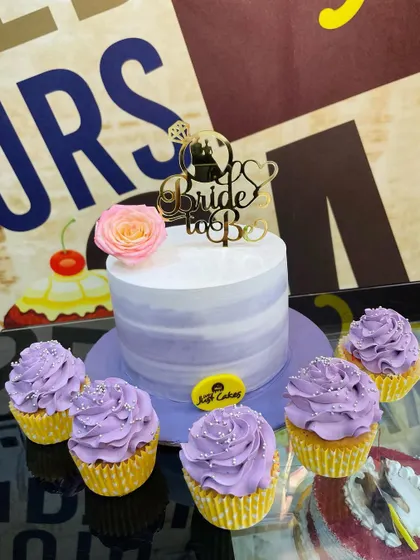 A 1.5kg "Bride to Be" cake with matching lavender cupcakes, perfect for a bridal shower.