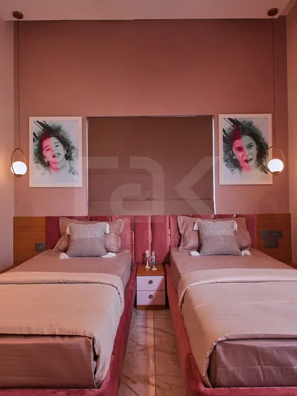 Twin beds in the enchanting kids' room, perfect for siblings, with individual pendant lights.