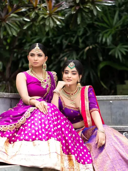 Two models showcasing our vibrant South Indian half sarees, demonstrating how different color combinations can create a stunning group look.