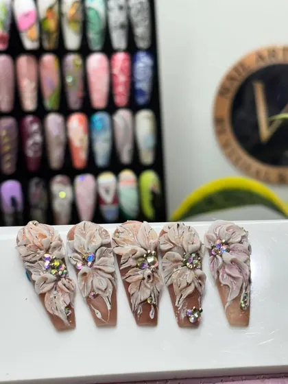 Another angle of our stunning 3D floral nail art, set against our extensive library of nail tip designs. This shows the level of detail and artistry you can expect from us.