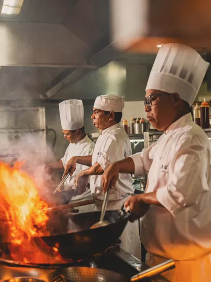 Capturing the intense energy of a professional kitchen. This shot of the chefs at Yauatcha Mumbai shows the fire and precision that goes into creating world-class cuisine.