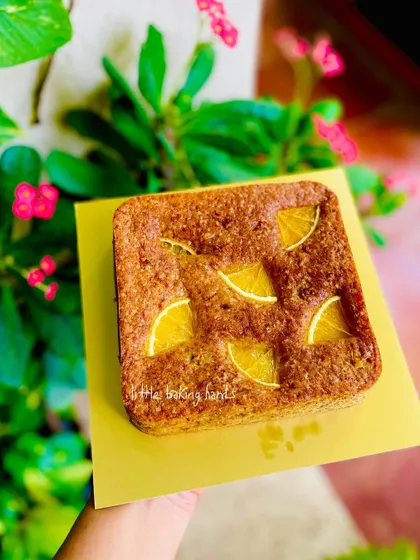 Another shot of the beautiful orange and ginger cake, with its bright colour set against a lovely green background.