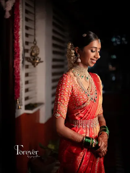 A low-angle shot of the bride, looking serene and beautiful. The makeup is subtle, allowing her natural grace to be the focus.