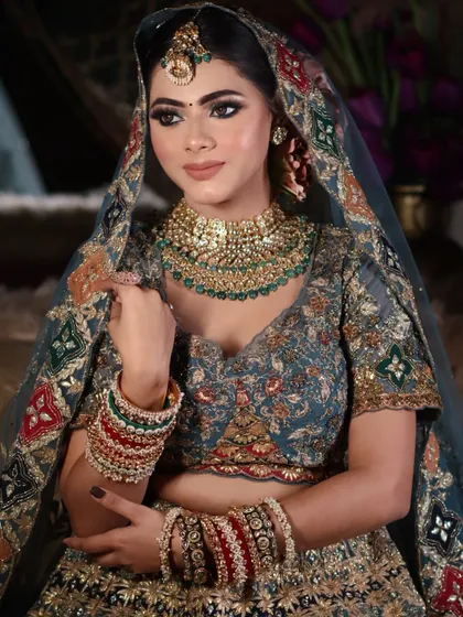 A three-quarter portrait that highlights the contour and blush work, as well as the detailed eye makeup.