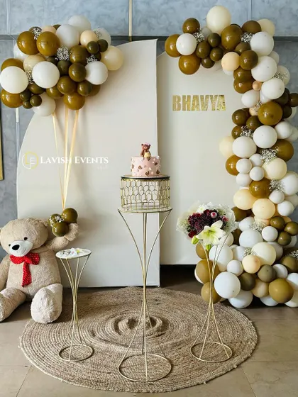 A charming teddy bear themed birthday setup with an earthy brown and white color scheme.