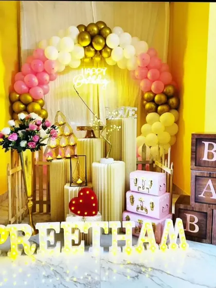 A lovely and affordable birthday setup featuring a balloon arch, 'BABY' blocks, and light-up letters. We can customize the colors to match your preference.