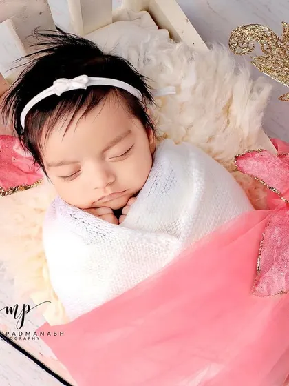 A close-up of the baby's face, showing her delicate features.
