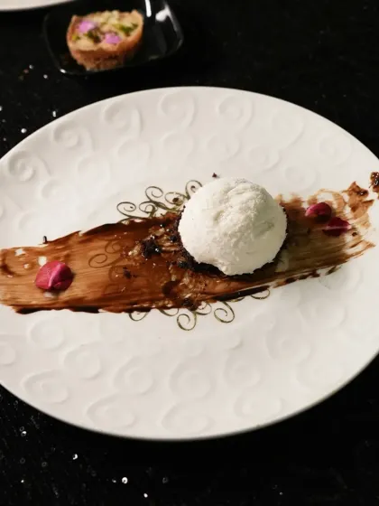 Artfully plated to highlight its simple elegance. A scoop of our Coconut Nutella mousse is brushed with chocolate, showcasing the smooth texture and inviting a taste of its unique flavour combination.