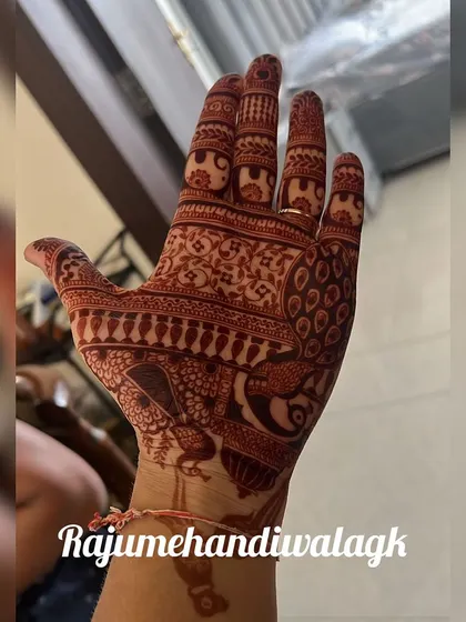 A classic design featuring a prominent peacock on the back of the hand. The intricate feather details and surrounding floral patterns show the fine linework we are capable of.