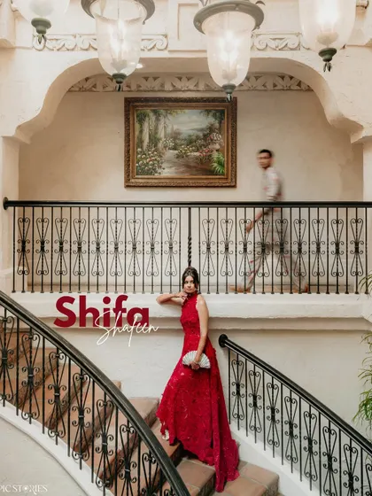 A dynamic portrait of the bride on the grand staircase of Villa Antonia in Austin. The motion blur of the groom in the background adds a narrative element to this beautifully composed shot.