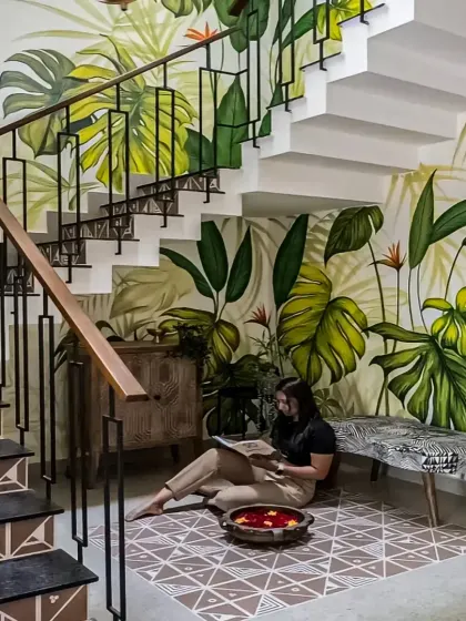 We used a vibrant, tropical-themed wallpaper to create a stunning accent wall along this staircase. This design brings nature indoors and adds a playful yet sophisticated touch to the space.