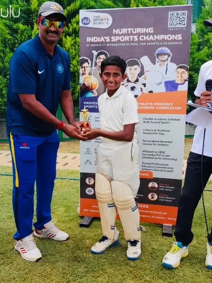 A proud moment for a young champion. One of our cricketers receives a trophy from a coach, recognizing his outstanding performance and contribution to the team's success.