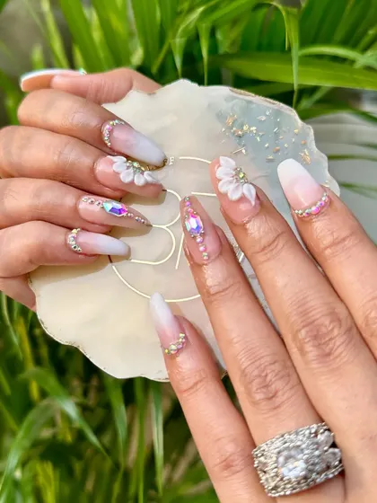 Step into a garden of elegance with these 3D floral and stone nails. This is a perfect look for a bride who wants beauty and sparkle with every gesture.