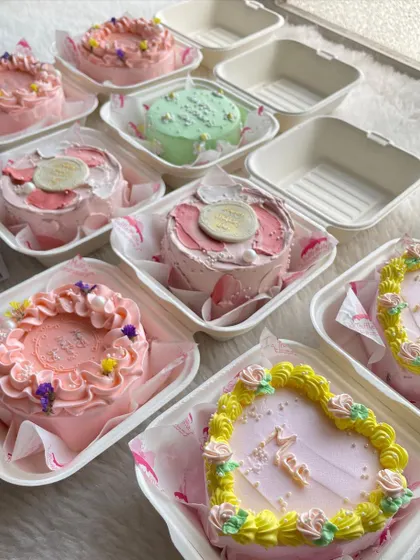 A whole array of Mother's Day bento cakes ready to be packed. I offered different designs and colors, including heart-shaped cakes and delicate floral piping.