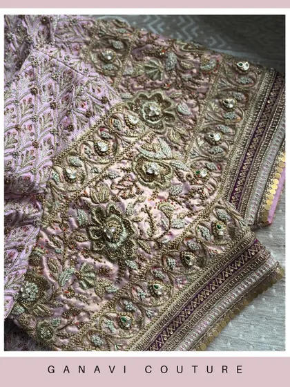 A rich tapestry of pink and gold embroidery. This detailed shot showcases the dense, luxurious handwork that adorns one of my signature bridal blouses, a testament to hours of dedicated craftsmanship.