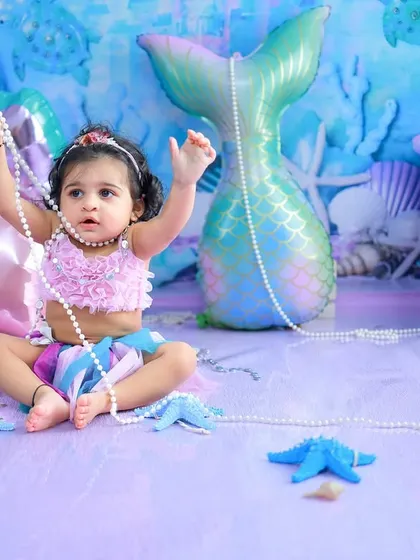 Playing with a string of pearls under the sea. The joy and wonder in her eyes are what make these themed sessions so special and memorable.