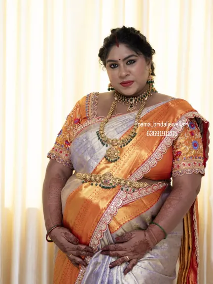 A full-length portrait showing her beautiful baby bump. The orange and silver saree is a unique choice, and the jewellery complements it perfectly.