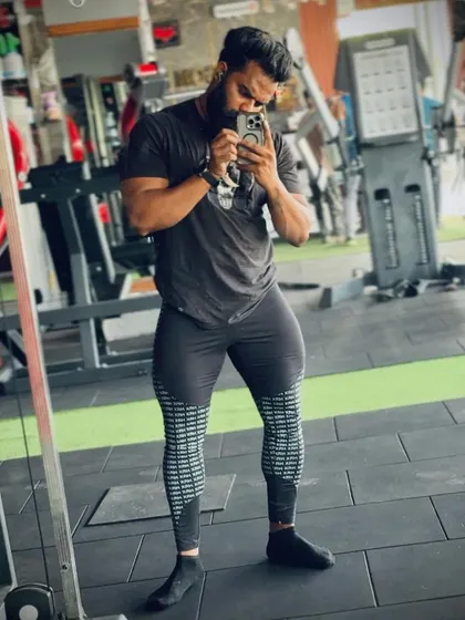 You can't have a strong body without strong legs. A client showing his impressive quadriceps development after a tough leg day.
