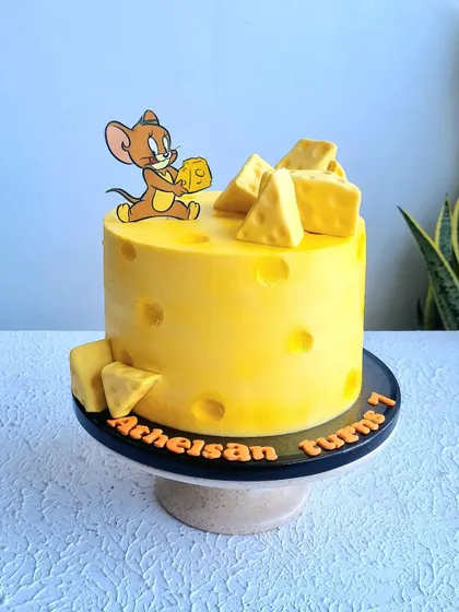 A full view of the Jerry and cheese cake on its stand.