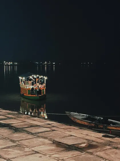 a boat docked at the ghats at night. the reflection on the water and the quiet stillness of the scene influence my approach to creating calm, focused user experiences.