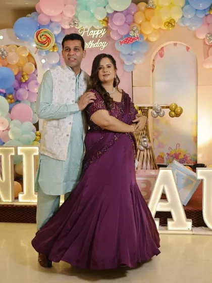 A perfect blend of tradition and trend. This couple looks wonderful together, with her in a custom purple draped gown that features an intricately embroidered bodice.