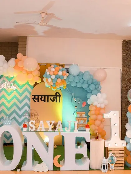 A magical 'Mermaid' themed birthday party, with shimmering blue and green decor, seashell props, and mermaid cutouts, creating an enchanting underwater world.