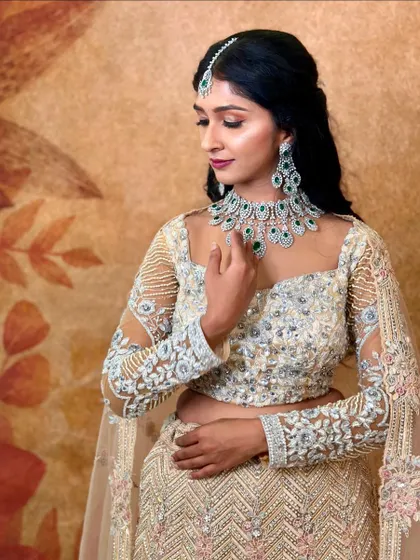 A gorgeous model in a modern lehenga, her look completed with my emerald and AD necklace set.