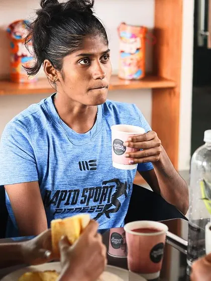 A candid moment of an athlete recharging between intense training sessions. These moments of mental rest are crucial for recovery, and our facilities are designed to provide spaces where athletes can relax and connect with their peers.