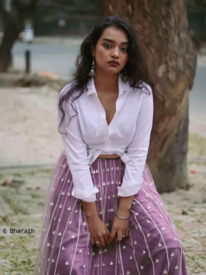 A full-length portrait that showcases the entire outfit in a relaxed, urban setting.