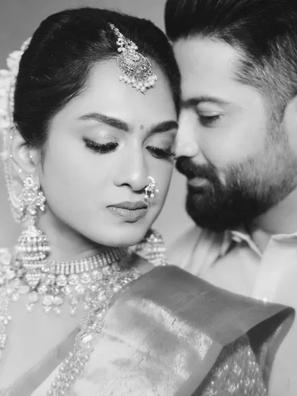 A timeless black and white portrait of the couple. The intimate pose and soft focus create a romantic and emotional image.