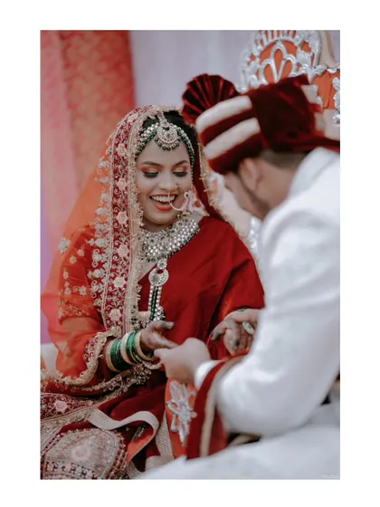 A joyful moment during a Muslim wedding ceremony (Nikah) as the groom puts the ring on the bride's finger.