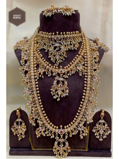 I believe in providing an "ekdum complete look," which is why most of my outfits come with jewellery. This is an example of a full bridal jewellery set available for rent, featuring multiple necklaces, earrings, and a maang tikka, all designed to complement a traditional bridal outfit.