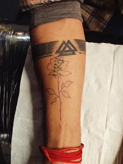 Before: A faded armband and symbol tattoo on the forearm. The client wanted a new, cleaner design.