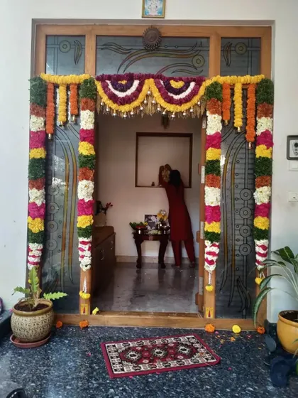 A beautiful floral decoration for a home entrance. The mix of colors and textures in the flower garlands creates a rich and festive look.