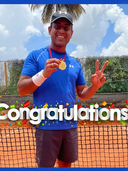A victory pose from one of our champions. This player proudly displays his winner's medal after a successful tournament, representing the competitive spirit we foster.