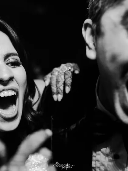 Pure, uninhibited joy! This close-up of guests laughing and shouting on the dance floor captures the soul of the party.
