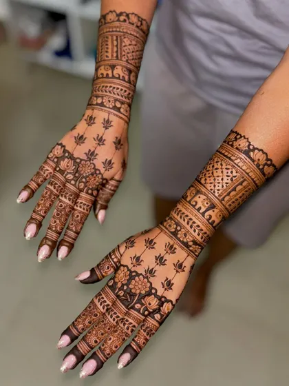 An angled view of the engagement mehendi with lotus and elephant motifs.