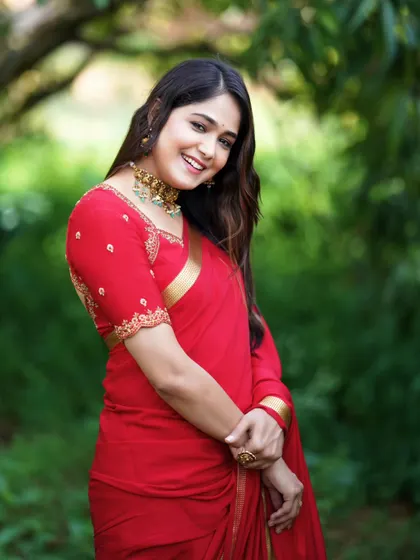 A happy and candid shot showcasing the beautiful red saree.