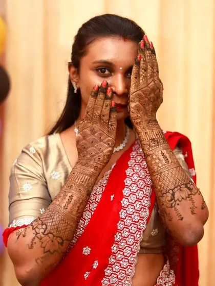A shy pose from a happy client, showcasing her intricate bridal mehndi. I love when my clients have fun and feel beautiful with their henna.