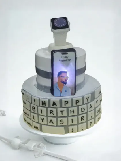 For the tech lover in your life, I create cakes that light up. This custom two-tier cake features an edible keyboard, a fondant Apple Watch, and an illuminated iPhone screen displaying a personal photo. It’s a unique design that’s guaranteed to be a conversation starter.