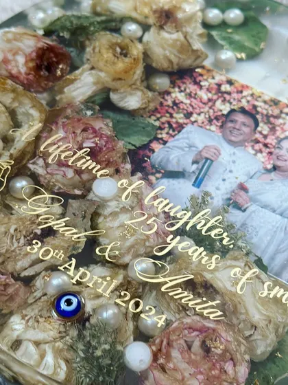 This 8-inch circular frame was created to celebrate a silver anniversary. The original varmala flowers were preserved to create a piece that honors 25 years of togetherness.