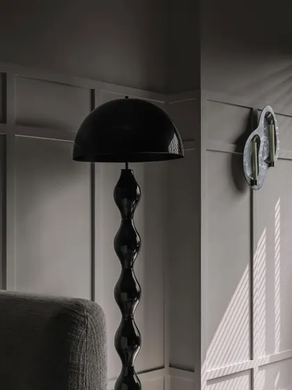 Another view of the lighting details at Frenchie Haus. The play of light and shadow against the wall paneling adds depth and drama to the room.