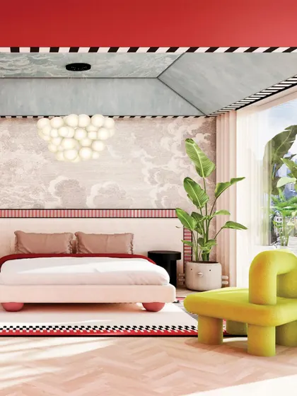 This bedroom is a perfect blend of pop art and classic design, with a cloud-like chandelier, a whimsical green chair, and a red-and-white color-blocked wall.