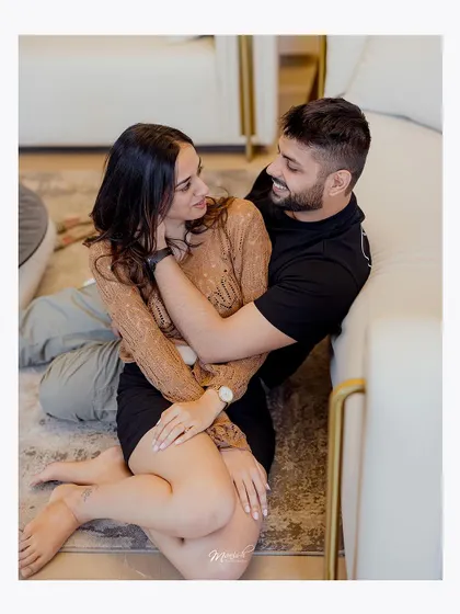 A tender moment on the floor, showing the comfort and intimacy the couple shares in their personal space.