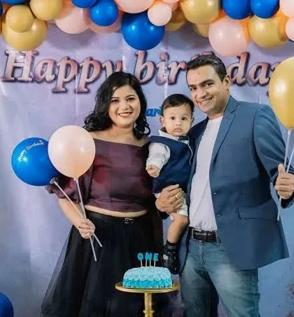 A first birthday celebration with the family holding balloons and posing with the cake. We capture all the key elements of this important milestone.