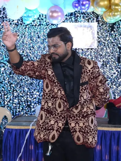 A magical gesture before the grand illusion. The anticipation is part of the fun in every magic performance I give.