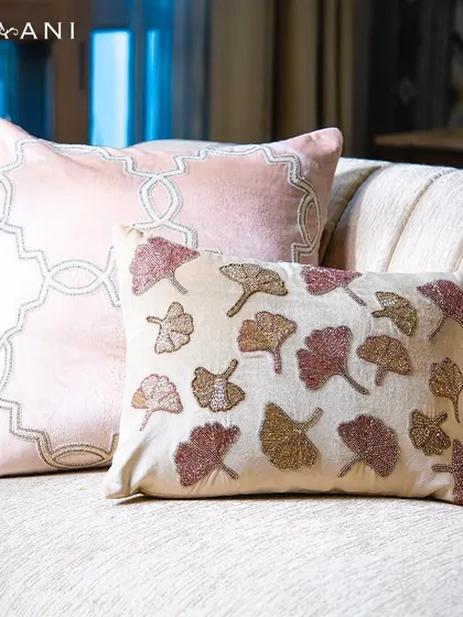 My lotus-embroidered velvet cushion is a piece of art. This close-up shows the beaded leaf patterns in shades of pink and gold, celebrating the quiet beauty of nature.