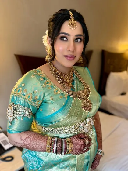 A lovely side profile showing off her baby bump. The makeup is soft and subtle, highlighting her features without being overpowering.