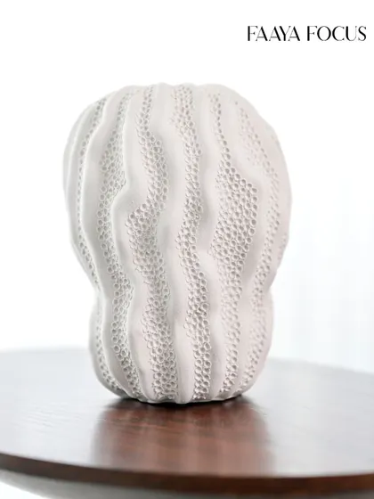 A closer look at the organic, brain-coral texture of this white ceramic vase. The intricate, undulating pattern gives it a soft, tactile quality that is both visually interesting and calming.
