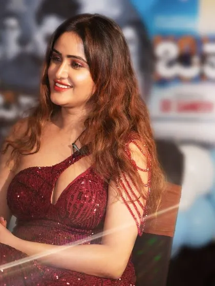 A candid shot of Sony Charishta during an event, capturing her natural smile and radiance. Event photography requires a different skill set to capture fleeting moments.